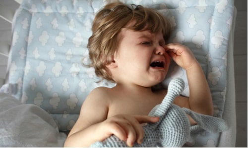 Baby crying in bed